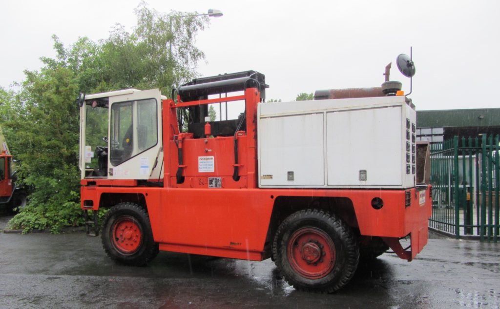 Diesel forklift with enclosed cab parked on site, configured for outdoor lifting and materials transport operations.